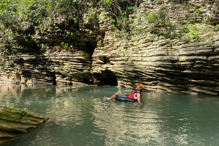 a group of people riding on the back of a boat in the water